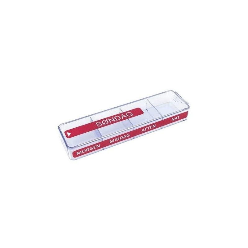 Gros plan d'un pilulier transparent à quatre compartiments avec marquages rouges pour dimanche et heures